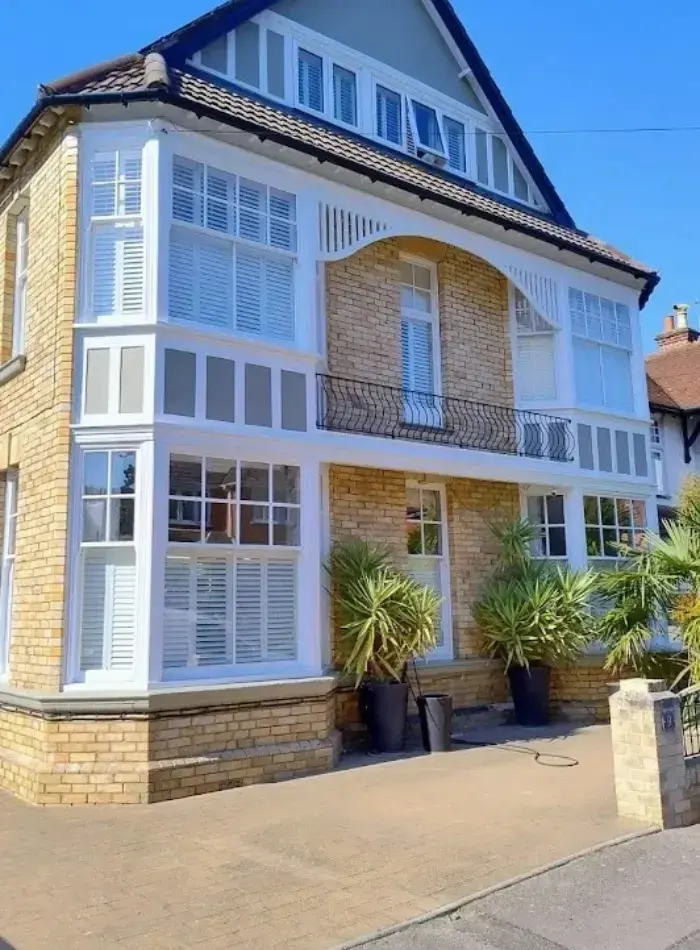 Restored Edwardian house facade with new windows and balcony